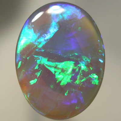 SOLID SEMI BLACK OPAL Large opal with rolling flashes of neon fire. SEE VIDEO